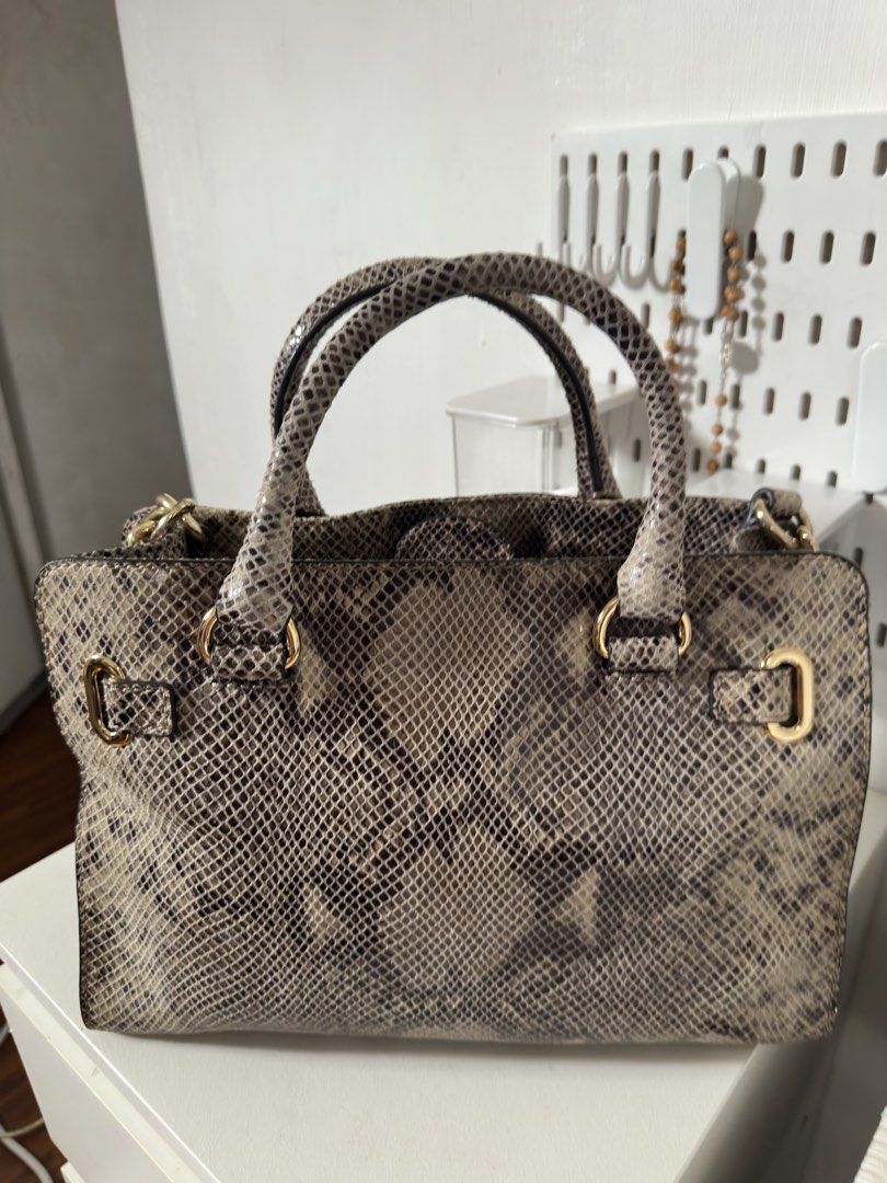 [ORIGINAL] Michael Kors Python Print Leather Satchel Handbag Gold Hardware (Category: Luxury Bags & Wallets) located in Manila. Submitted by r.ivrsn (Listing ID 1464594083, Image 3). Description: - Stylish Michael Kors satchel bag (BOUGHT IN JAPAN) - Eye-catching all-over python print - Elegant gold hardware and buckle details - Comfortable top handles - Includes a detachable shoulder strap for versatility - Spacious interior, ideal for everyday 