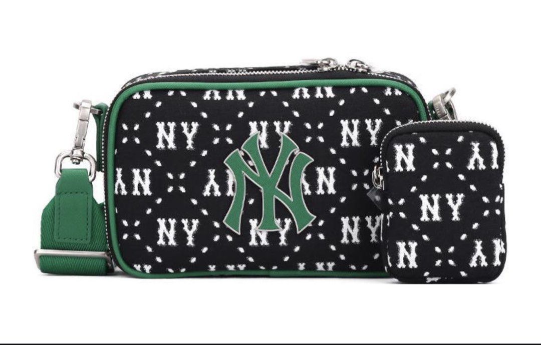 Original MLB Bags (Category: Cross-body Bags) located in Manila. Submitted by vengonflo (Listing ID 1464727380, Image 3). Description: Black and green crossbody bag by MLB. Features the New York Yankees NY logo front and center. All-over patterned canvas material with green piping trim. Detachable green shoulder strap and a matching small zippered pouch attached to the side. Silver hardware zippers and clasps. Brand new with tags attached..