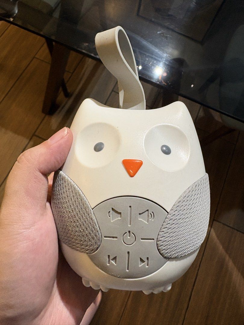Owl Noise Machine for Baby (Category: Other Kids Furniture) located in Taguig. Submitted by alys.m (Listing ID 1464724873, Image 1). Description: - Adorable white and grey owl design with stylish fabric wing speaker grilles - Features convenient belly buttons for power, volume, play, and skip control - Cute orange beak accent and top silicone strap for easy hanging and portability - Compact and lightweight size, perfect for everyday use.