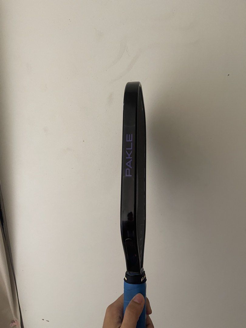Pakle Fuse Elongated Pickleball Paddle (Category: Racket and Ball Sports) located in Maddela. Submitted by ft4qmvk8nv (Listing ID 1464578946, Image 2). Description: Pakle Fuse Pickleball Paddle Condition: 9.9/10. Used 4 times only. Paint Protection Film (PPF) installed since day 1. Comes with original cover. Bought in Sampaguita Pickleball Store Negotiableeee Rfs. Bought a new Paddle.