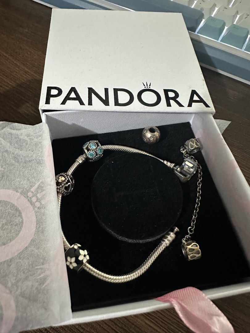 Pandora Silver Charm Bracelet with Multiple Charms and Box (Category: Bracelets) located in Iligan City. Submitted by curatedcloset9200 (Listing ID 1464693848, Image 1). Description: - Authentic Pandora silver charm bracelet with standard snake chain and threaded barrel clasp - Pre-styled with a stunning mix of charms: black floral enamel, blue crystal ball, textured openwork beads, and a dangling safety chain - Comes complete with original Pando