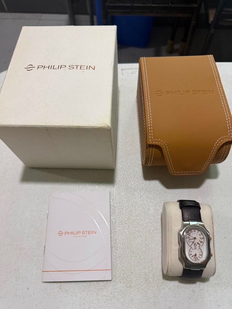 Philip Stein Dual Time Watch with Box (Category: Women's Watches) located in Pasig City. Submitted by arjane1119 (Listing ID 1464761983, Image 1). Description: - Brand: Philip Stein Dual Time Wristwatch - Case: Stainless steel curved rectangular case with dual crowns for independent time zones - Strap: Black genuine lizard leather strap with buckle closure - Inclusions: Original branded outer box, tan leather presentation case, and instruction bo