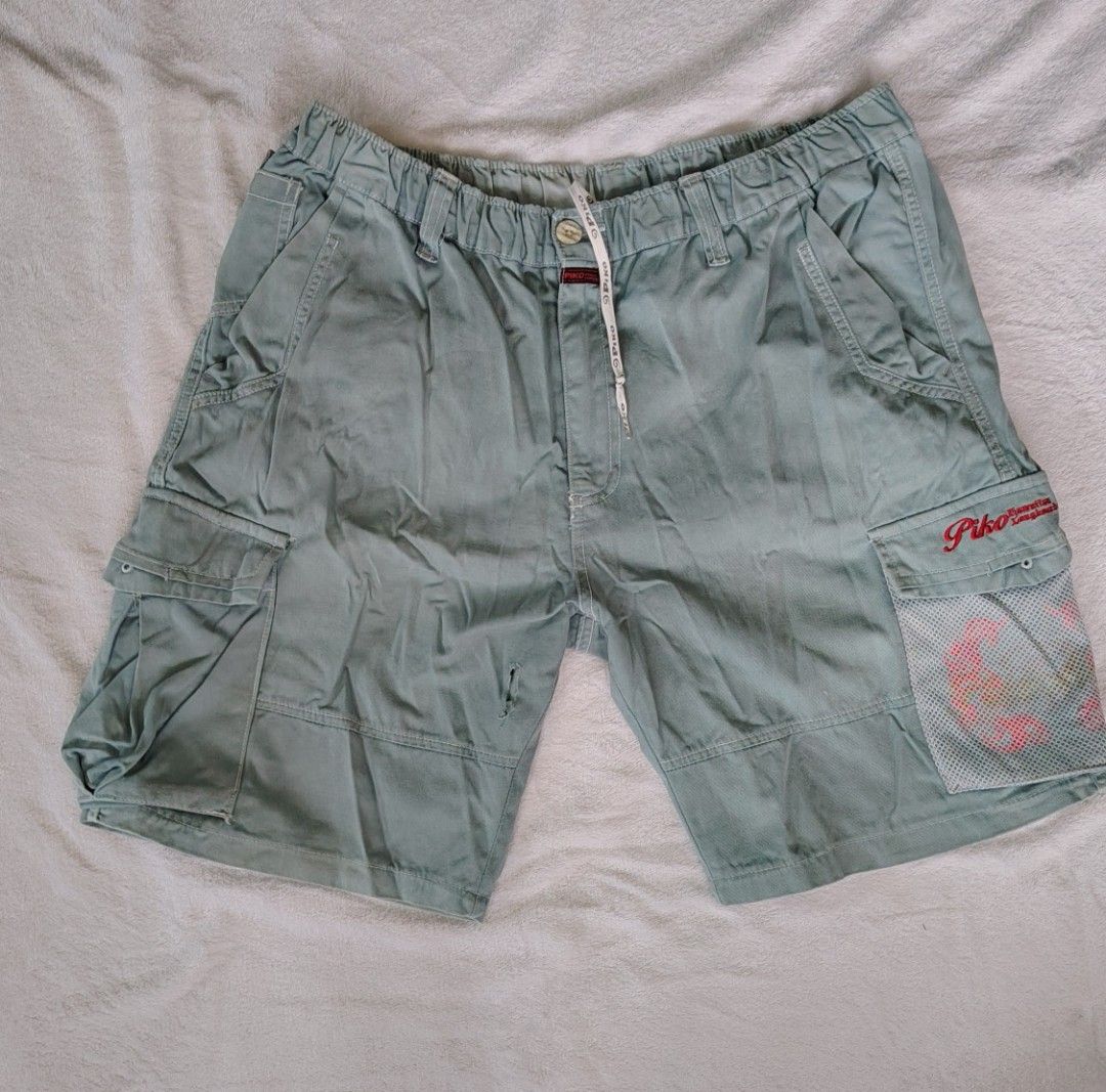 Piko Cargo Shorts Light Blue (Category: Shorts) located in Manila. Submitted by another_wear31. (Listing ID 1464573423, Image 1). Description: - Light blue cargo shorts - Drawstring waist for adjustable fit - Multiple pockets on front and sides - Unique mesh pocket with graphic print on right leg - Ideal for everyday casual wear -size 22× 28-32.