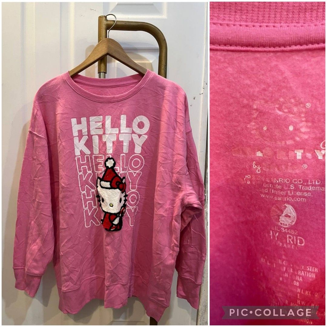 Pink Hello Kitty Sweatshirt Hybrid Apparel (Category: Coats, Jackets and Outerwear) located in Quezon City. Submitted by chicberry (Listing ID 1464766569, Image 1). Description: - Vibrant bright pink Kitty sweatshirt - Festive fuzzy Santa hat detail on the front - Bold repeating white " Kitty" text - Cozy soft fleece interior for warmth - Classic ribbed collar, cuffs, and hem - Comfortable tagless collar by Hybrid Apparel.