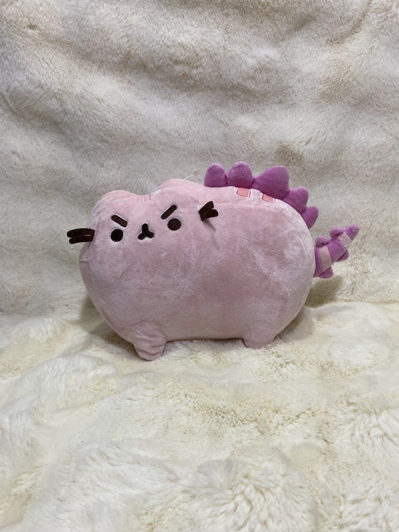 Pink Pusheen cat/dino plush (Category: Plushies & Soft Toys) located in Kalibo. Submitted by ollie_stuffshop (Listing ID 1464579467, Image 1). Description: 20cm x 29cm Before you send your inquiries: ❗️Last Price is already posted ❗️Manage your expectations, WYSIWYG ❗️May need washing ❗️Dropoff is every Wednesday & Sunday.