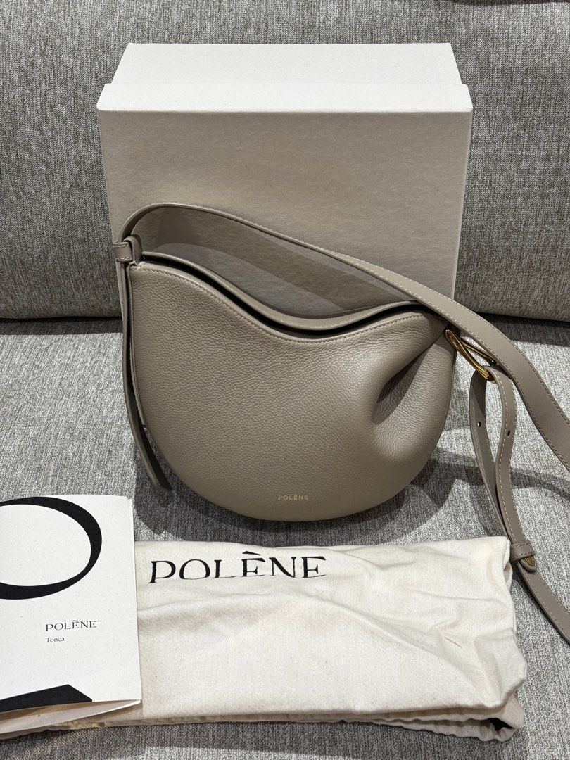 Polène Tonca Bag Taupe Grained Leather (Category: Luxury Bags & Wallets) located in Pateros City. Submitted by lmnsi (Listing ID 1464648839, Image 1). Description: Polène Tonca Bag – Taupe * Color: Taupe * Material: Grained Leather * Condition: Like new, barely used * Includes: Original dust bag and box * Reason for Selling: Too many bags 🥹 Note on condition: There are two very small, faint watermarks near the top opening of the bag. They are ba