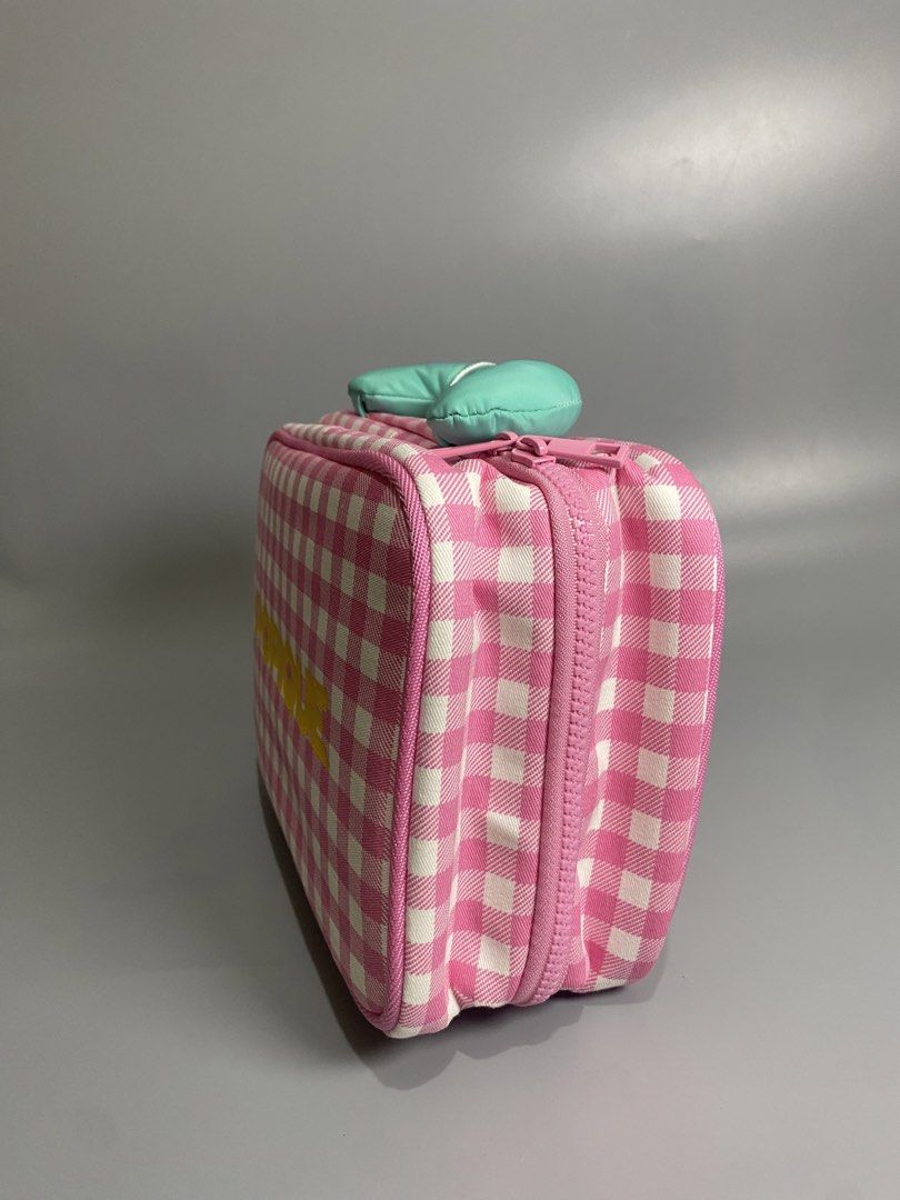 POPIQUE Pink Gingham Hanging Toiletry Bag (Category: Purses & Pouches) located in Davao. Submitted by brandedthrift.134 (Listing ID 1464735824, Image 3). Description: - Brand: POPIQUE - Design: Pink and white checkered pattern with a yellow logo on the front - Features: Mint green top handle, convenient hanging hook inside, and multiple pink mesh zippered compartments - Condition: Brand new with original tag attached, comes in original clear plas