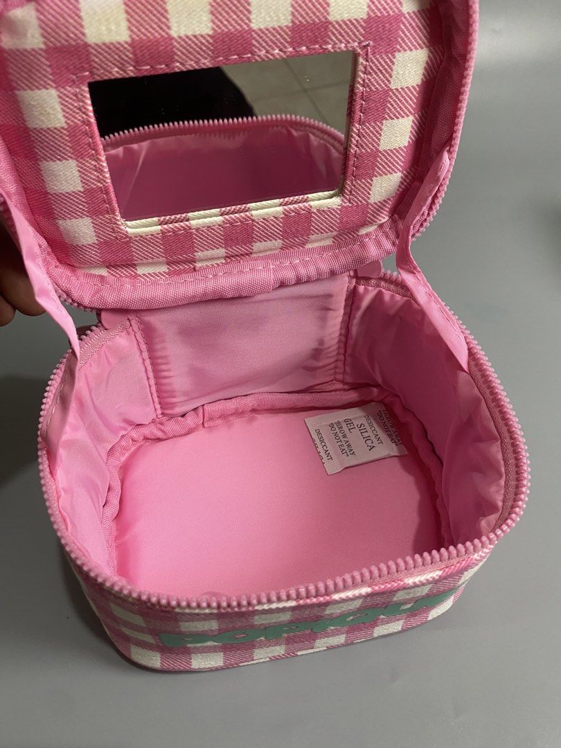 POPIQUE Pink Gingham Makeup Vanity Bag with Mirror (Category: Purses & Pouches) located in Davao. Submitted by brandedthrift.134 (Listing ID 1464736491, Image 2). Description: - Brand: POPIQUE (Brand New with Tags) - Design: Pink & white gingham pattern with teal puffy handle and matching front text - Interior: Pink lining with built-in mirror inside the lid - Closure: Zip-around closure - Packaging: Packed in a clear plastic storage bag.
