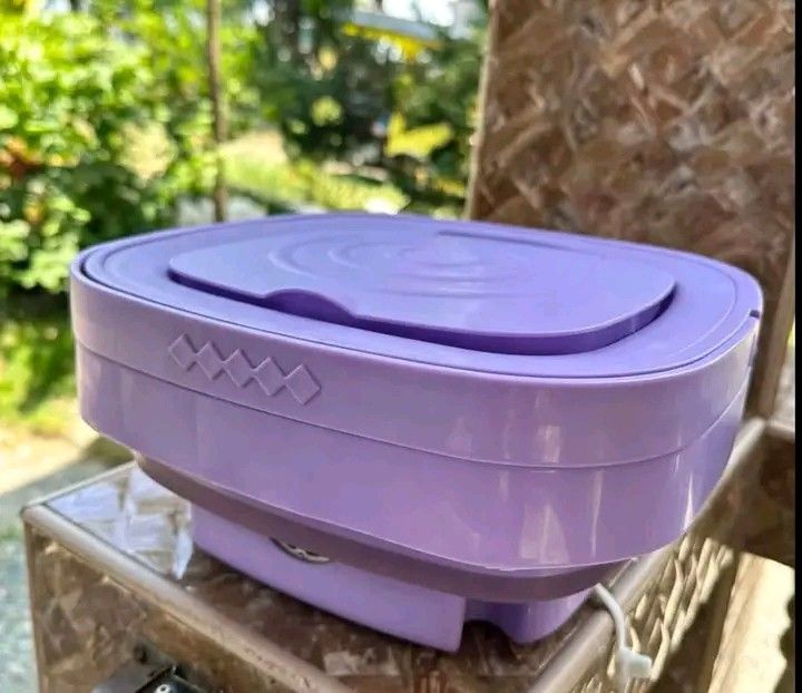 Portable Foldable Mini Washing Machine with Handle Purple (Category: Washing Machines and Dryers) located in Manila. Submitted by berdenmarl01688 (Listing ID 1464748344, Image 3). Description: Purple portable mini washing machine. Collapsible design saves space when storing. Includes internal tub, pulsator, and drain hose. Great for small loads, undergarments, or dorm rooms. Powered unit with control buttons on the front. Handle attached for carr