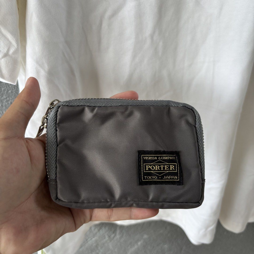 Porter wallet (Category: Belt bags, Clutches and Pouches) located in San Fernando. Submitted by diff.thr1ft (Listing ID 1464584838, Image 1). Description: - Authentic Porter wallet - Color: Gray - Material: Durable nylon - Features multiple compartments for organization - Smooth zipper closure.