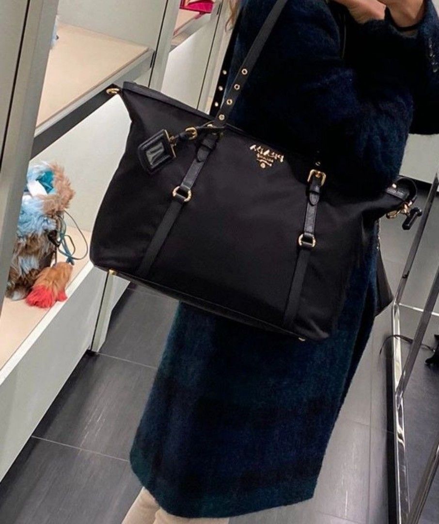 Prada (Category: Tote Bags) located in Caloocan City. Submitted by mylove326 (Listing ID 1461431160, Image 3). Description: - Material: Nylon with Leather Details - Hardware: Gold - Includes: Dust Bag and Straps - Features: Spacious Interior - Ideal for: Everyday Use or Travel -Can use as shoulder bag or hand bag.