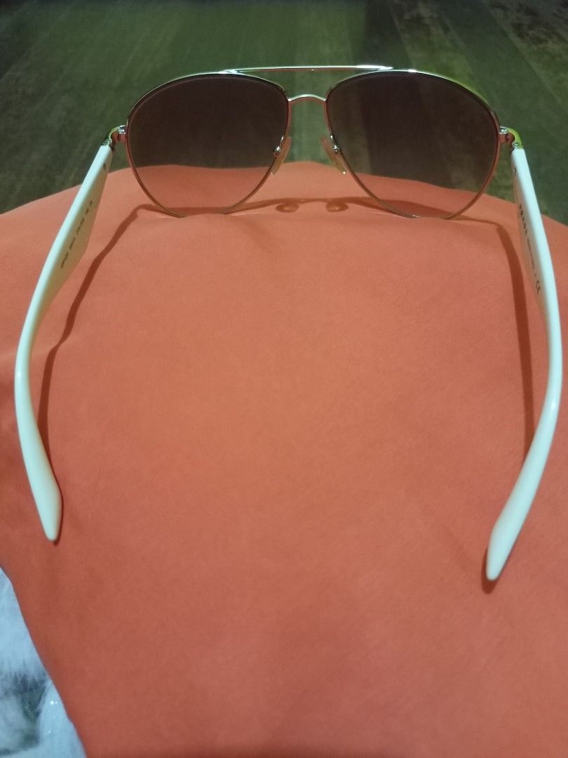 Prada Aviator Sunglasses Pink Lenses (Category: Sunglasses & Eyewear) located in Marikina City. Submitted by greyz.regginne_27 (Listing ID 1464570348, Image 3). Description: - Prada aviator sunglasses - Pink tinted lenses - White arms with gold accents - Made in Italy - Prada logo on the side - Ideal for sunny days.