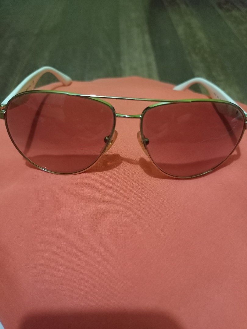 Prada Aviator Sunglasses Pink Lenses (Category: Sunglasses & Eyewear) located in Marikina City. Submitted by greyz.regginne_27 (Listing ID 1464570348, Image 1). Description: - Prada aviator sunglasses - Pink tinted lenses - White arms with gold accents - Made in Italy - Prada logo on the side - Ideal for sunny days.
