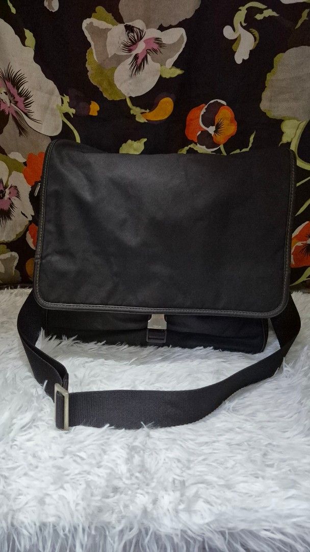 Prada Black Nylon Messenger Bag (Category: Luxury Bags & Wallets) located in Baguio. Submitted by jhaz_bags (Listing ID 1464705256, Image 1). Description: - Authentic Prada messenger bag in classic black nylon - Durable Saffiano leather trim and silver-tone hardware - Adjustable shoulder strap with secure plastic buckle closure - Spacious main compartment lined with signature Prada jacquard fabric - Interior zipped pocket for safe storage of esse