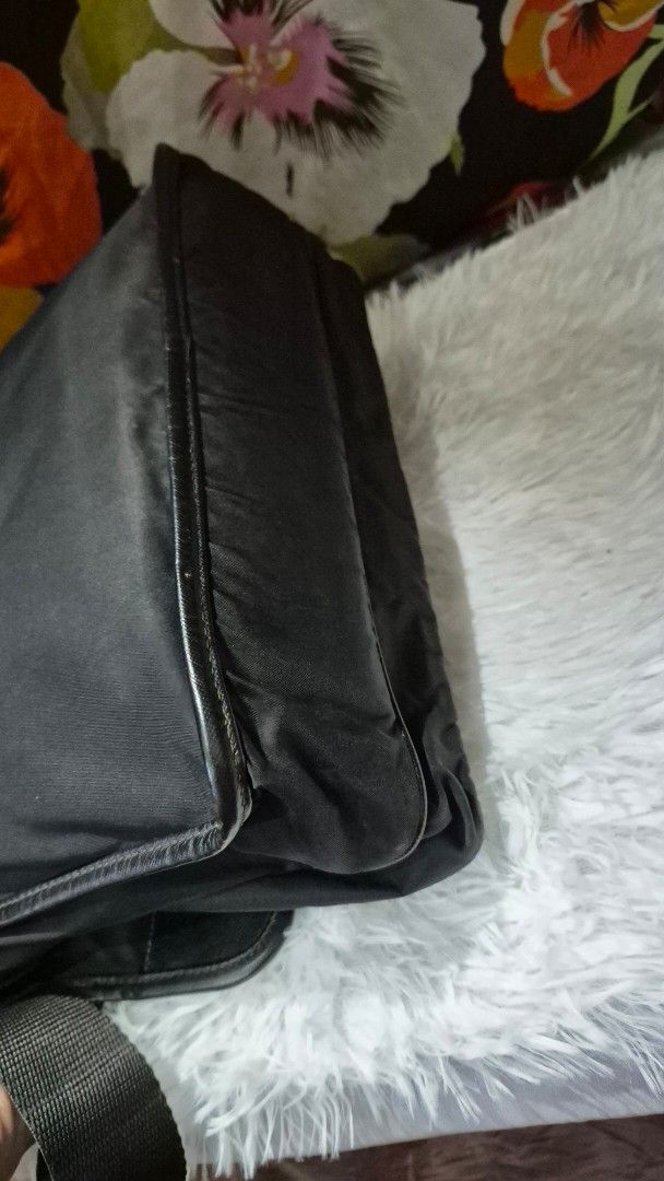 Prada Black Nylon Messenger Bag (Category: Luxury Bags & Wallets) located in Baguio. Submitted by jhaz_bags (Listing ID 1464705256, Image 3). Description: - Authentic Prada messenger bag in classic black nylon - Durable Saffiano leather trim and silver-tone hardware - Adjustable shoulder strap with secure plastic buckle closure - Spacious main compartment lined with signature Prada jacquard fabric - Interior zipped pocket for safe storage of esse