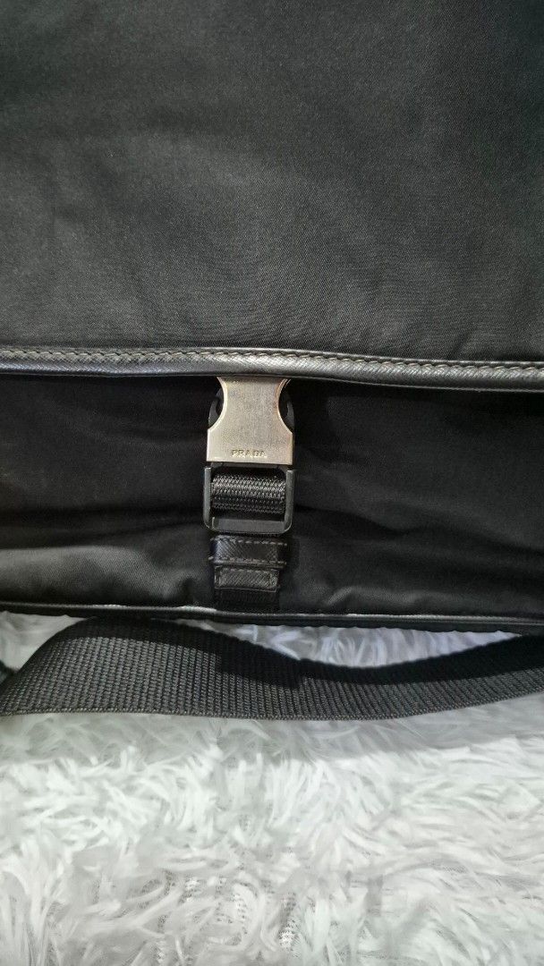 Prada Black Nylon Messenger Bag (Category: Luxury Bags & Wallets) located in Baguio. Submitted by jhaz_bags (Listing ID 1464705256, Image 2). Description: - Authentic Prada messenger bag in classic black nylon - Durable Saffiano leather trim and silver-tone hardware - Adjustable shoulder strap with secure plastic buckle closure - Spacious main compartment lined with signature Prada jacquard fabric - Interior zipped pocket for safe storage of esse