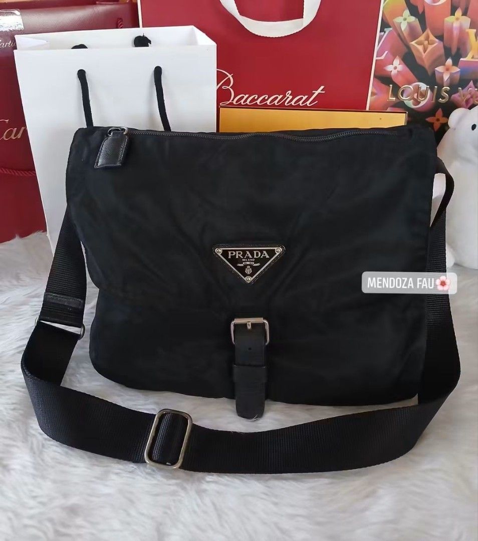 Prada Black Nylon Messenger Bag Crossbody (Category: Luxury Bags & Wallets) located in Masinloc. Submitted by normanmndz31986 (Listing ID 1464756153, Image 1). Description: - Authentic Prada black nylon messenger bag - Iconic enamel triangle logo and sleek silver-tone hardware - Adjustable web strap for comfortable, hands-free wear - Secure front flap with buckle closure and a handy zipper pocket on top - Stylish leather trim details on the sides
