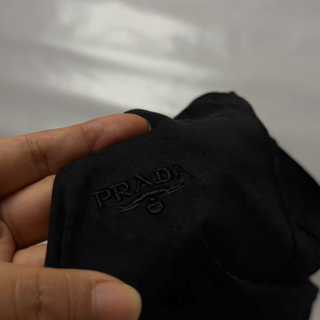 Prada Black T-Shirt Size XXL (Category: Tshirts & Polo Shirts ) located in Manila. Submitted by johnedel_james (Listing ID 1464688496, Image 3). Description: - Brand: Prada - Color: Black - Style: Short sleeve crew neck t-shirt with tonal chest logo embroidery - Material: 100% cotton - Origin: Made in Romania - Tag Size: XXL - Measurements: ~23" across chest (pit-to-pit), ~28" in length - Condition: Clean overall, no major flaws.