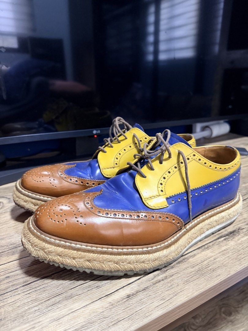 Prada Creepers Multi-Color Leather Brogues Espadrilles (Category: Casual Shoes) located in Manila. Submitted by impulsivebuyer1380 (Listing ID 1464766504, Image 1). Description: - Brand: Prada Creepers Size : 6.5 - Style: Multi-color leather wingtip brogues with espadrille jute midsole and grooved rubber sole - Colorway: Striking combination of blue, yellow, and brown - Details: Brown laces, tan leather interior lining, and stamped Prada branding