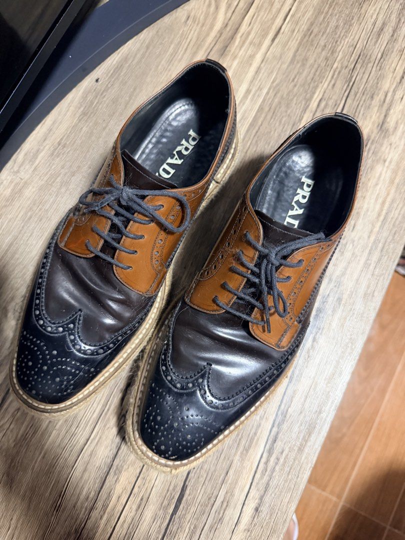 Prada Creepers Two-Tone Brogue Espadrilles (Category: Casual Shoes) located in Manila. Submitted by impulsivebuyer1380 (Listing ID 1464766711, Image 2). Description: - Brand: Prada Size: 40 | 6 Mens - Style: Two-tone leather brogues with chunky espadrille jute sole - Colorway: Dark brown and tan leather with dark grey laces - Features: Classic wingtip toe cap detailing and branded leather insoles - Condition: Noticeable creasing on the leather up
