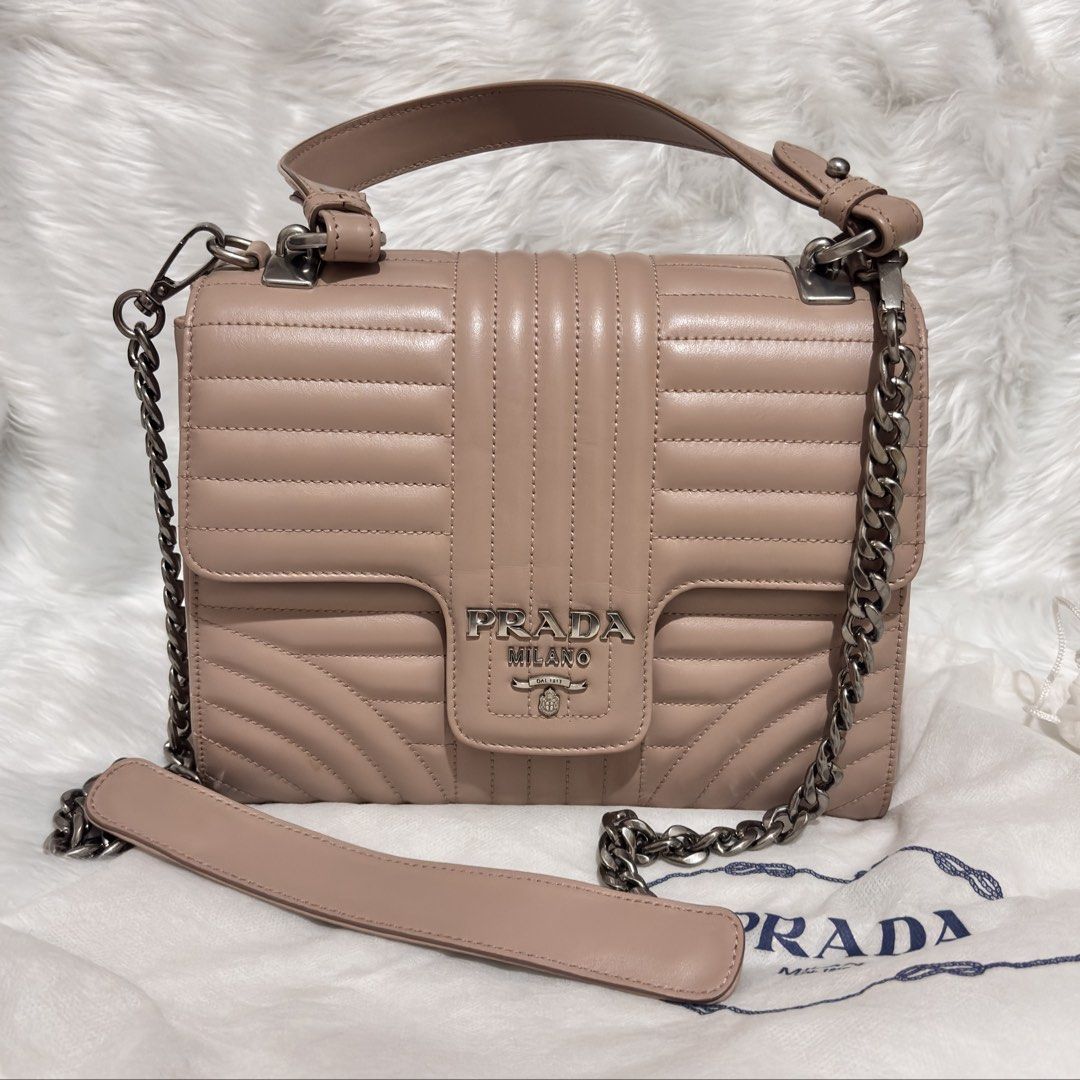 Prada Diagramme Medium Flap Shoulder Bag (Category: Other Accessories) located in Quezon City. Submitted by leens.preloved (Listing ID 1462682312, Image 1). Description: - Authentic Prada Bag - Color: Beige - Design: Quilted detailing - Strap: Chunky silver chain - Condition: Great, used only a few times - Size: Perfect for essentials.