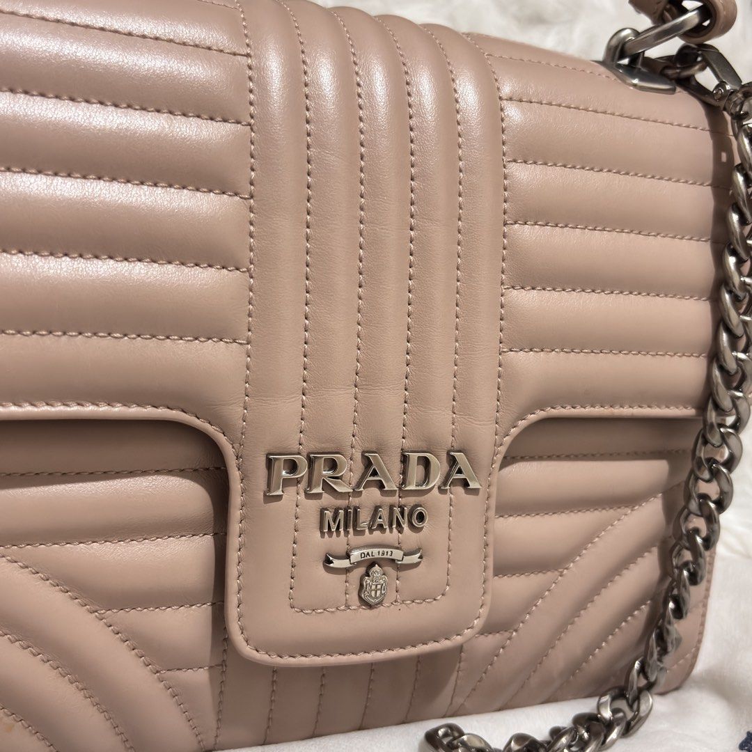Prada Diagramme Medium Flap Shoulder Bag (Category: Other Accessories) located in Quezon City. Submitted by leens.preloved (Listing ID 1462682312, Image 2). Description: - Authentic Prada Bag - Color: Beige - Design: Quilted detailing - Strap: Chunky silver chain - Condition: Great, used only a few times - Size: Perfect for essentials.