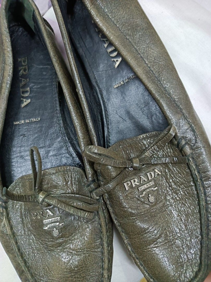 Prada Leather Loafers Made in Italy (Category: Loafers) located in Manila. Submitted by pnjdianne25879 (Listing ID 1464581184, Image 2). Description: - Authentic Prada Loafers - Made in Italy - Genuine Leather - Classic Slip-on Style - Small Bow Detail on Front - Comfortable and Stylish.