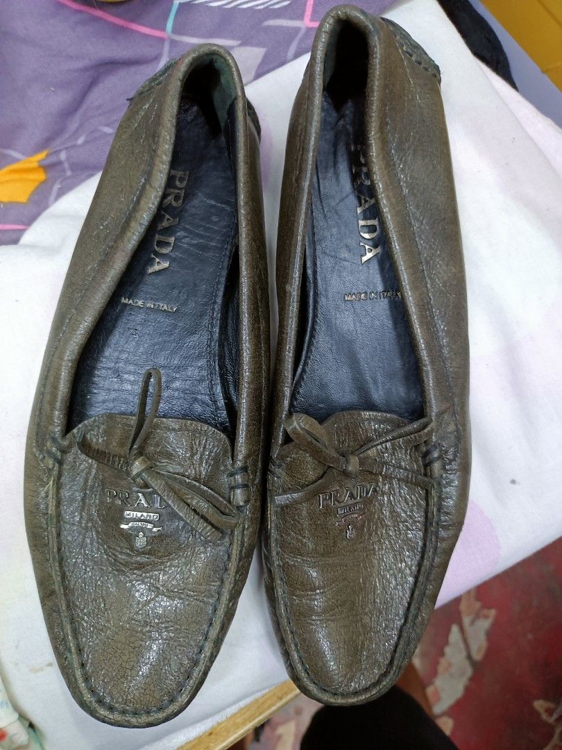 Prada Leather Loafers Made in Italy (Category: Loafers) located in Manila. Submitted by pnjdianne25879 (Listing ID 1464581184, Image 1). Description: - Authentic Prada Loafers - Made in Italy - Genuine Leather - Classic Slip-on Style - Small Bow Detail on Front - Comfortable and Stylish.