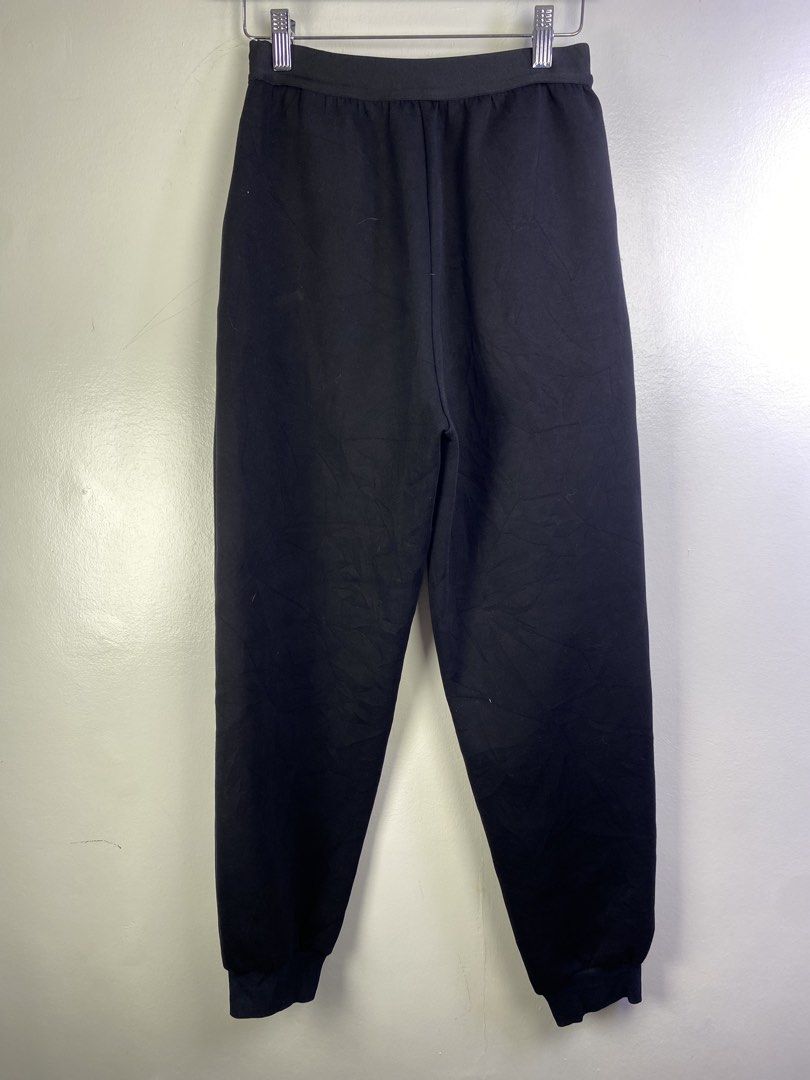 Prada Milano Black Jogger Pants (Category: Joggers) located in Manila. Submitted by declutterpromax (Listing ID 1464601126, Image 3). Description: - Prada Milano Jogger Pants - Color: Black - Size: M - Features elastic waistband with Prada Milano logo - Made in Italy - Perfect for comfortable and stylish casual wear.