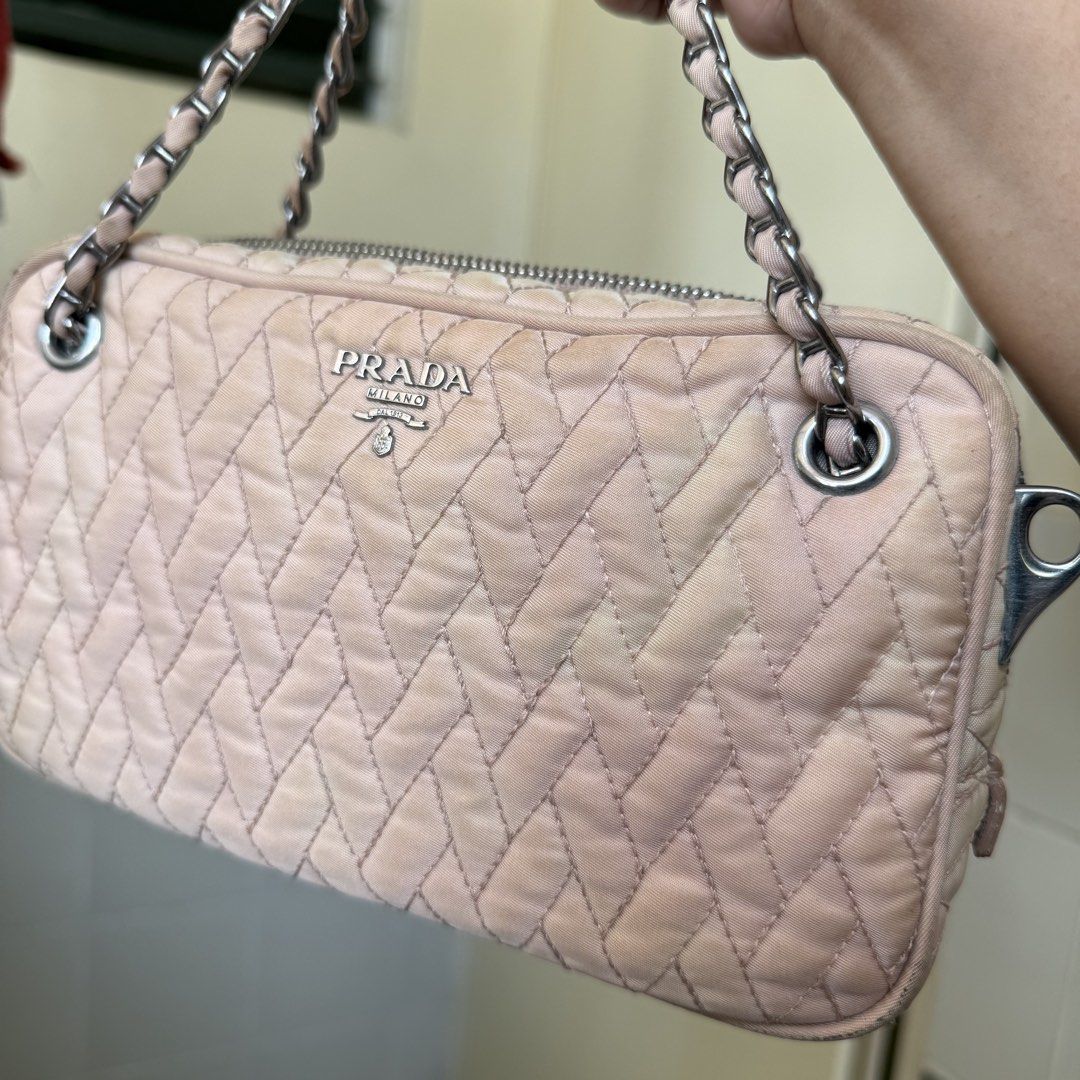 Prada Nylon Tessuto Quilted Crossbody Bag (Category: Luxury Bags & Wallets) located in Cebu City. Submitted by cdwears (Listing ID 1464596542, Image 3). Description: - Authentic Prada bag - With cards and dust bag (forgot to picture) - Vintage nude pink quilted nylon material - Used many times my go to bag - Silver hardware - Multiple interior compartments - Some signs of wear on exterior - Comes with a detachable leather strap (no chipping) - Id
