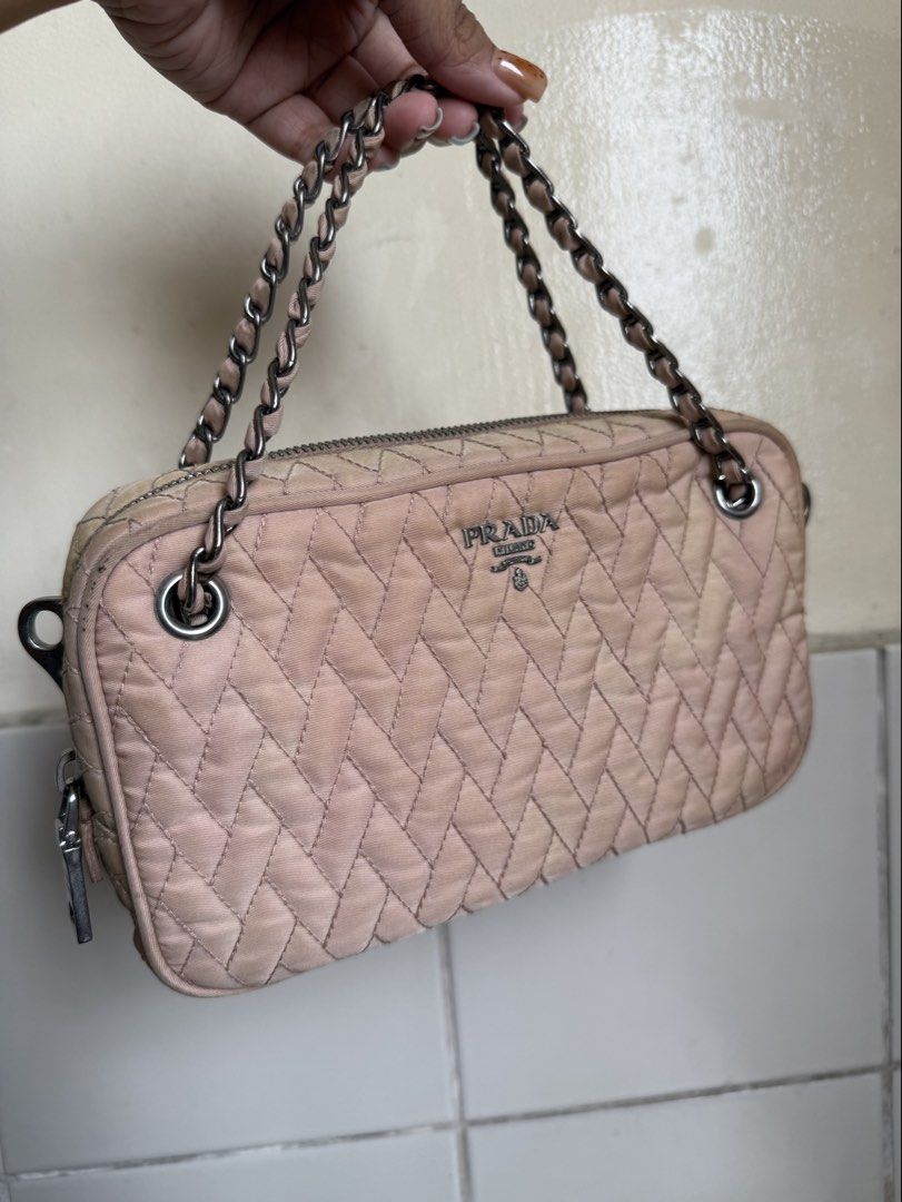 Prada Nylon Tessuto Quilted Crossbody Bag (Category: Luxury Bags & Wallets) located in Cebu City. Submitted by cdwears (Listing ID 1464596542, Image 1). Description: - Authentic Prada bag - With cards and dust bag (forgot to picture) - Vintage nude pink quilted nylon material - Used many times my go to bag - Silver hardware - Multiple interior compartments - Some signs of wear on exterior - Comes with a detachable leather strap (no chipping) - Id