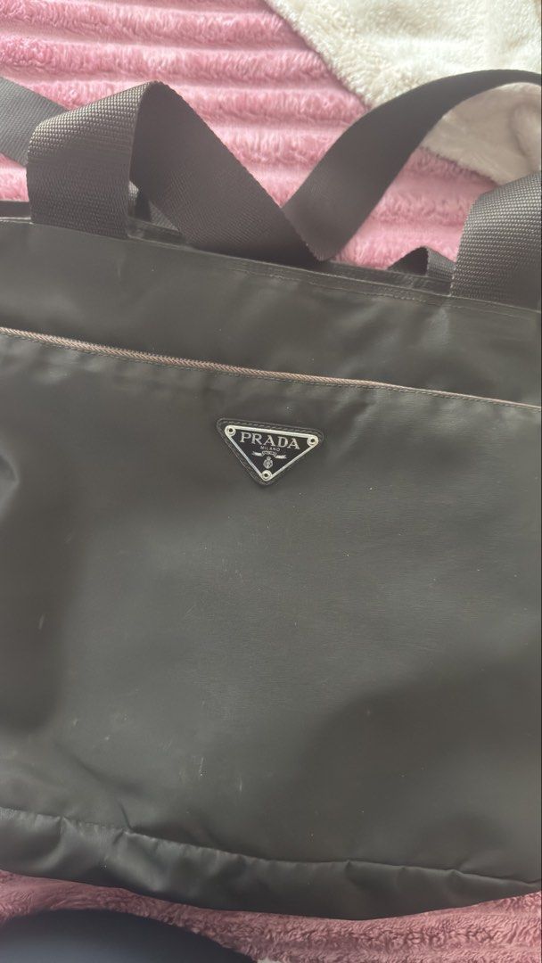 Prada Nylon Tote Bag (Category: Luxury Bags & Wallets) located in Pasig City. Submitted by cecilececile4361 (Listing ID 1452254083, Image 3). Description: - Classic Prada tote bag - Durable nylon material - Iconic Prada triangle logo on front - Spacious interior - Comfortable handles - Versatile for daily use.
