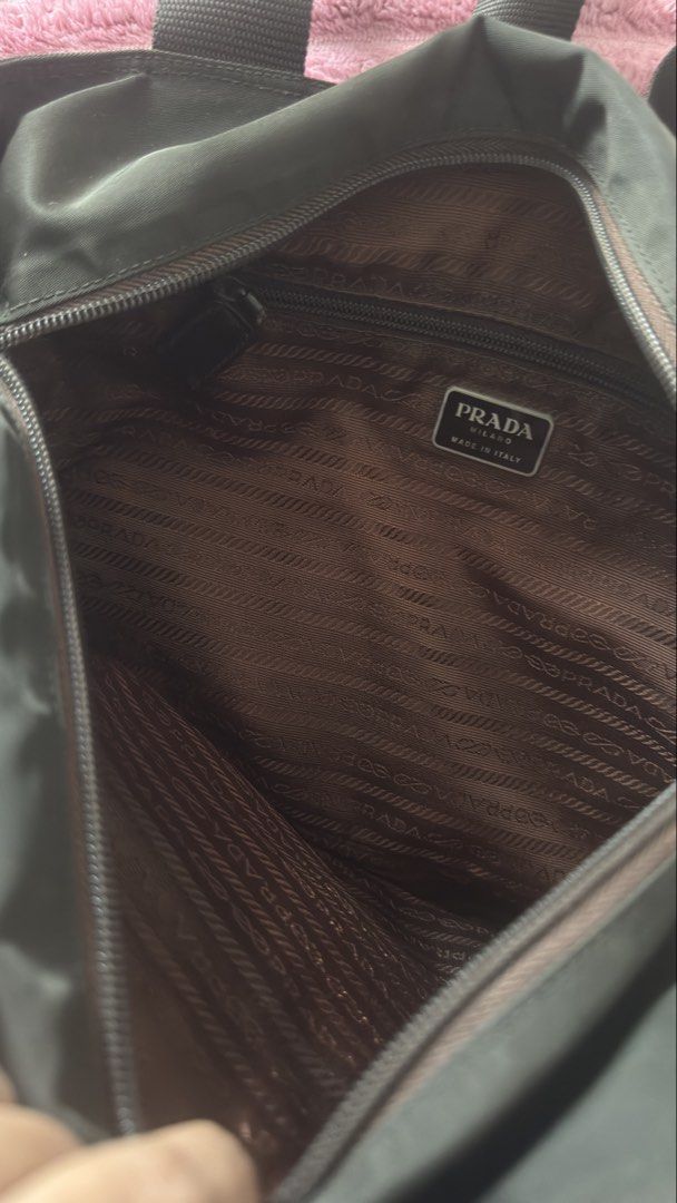 Prada Nylon Tote Bag (Category: Luxury Bags & Wallets) located in Pasig City. Submitted by cecilececile4361 (Listing ID 1452254083, Image 2). Description: - Classic Prada tote bag - Durable nylon material - Iconic Prada triangle logo on front - Spacious interior - Comfortable handles - Versatile for daily use.