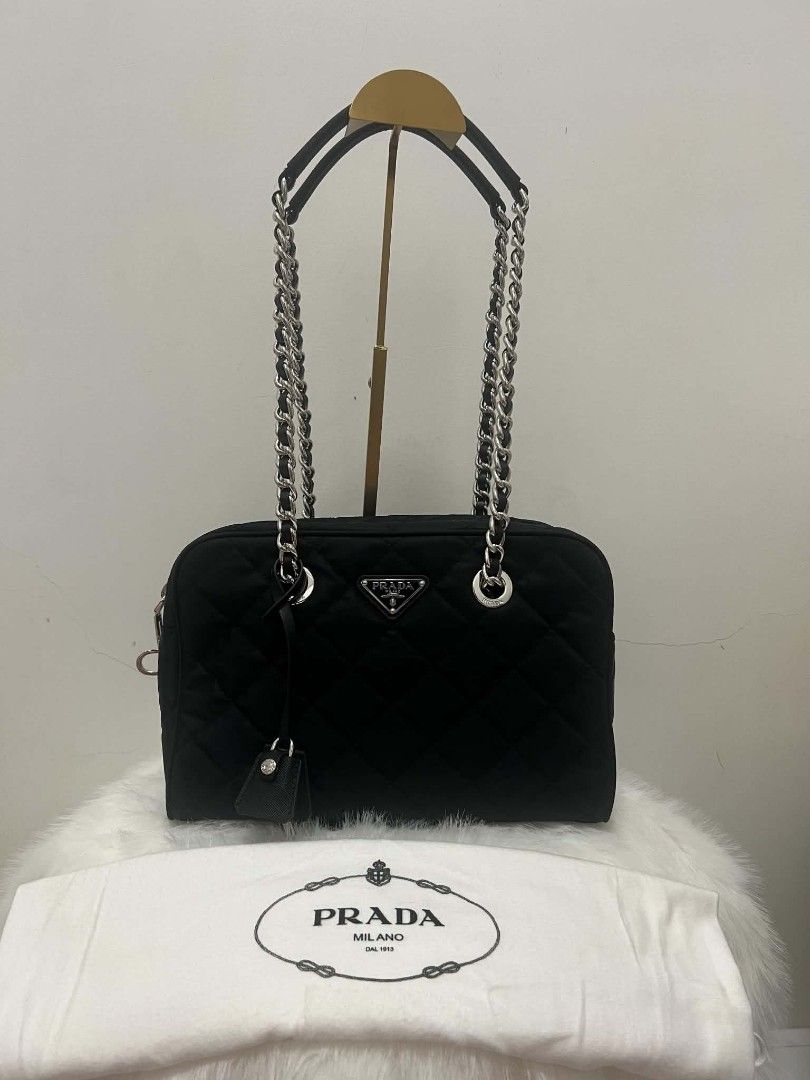 Prada Quilted Nylon Chain Shoulder Bag Black (Category: Luxury Bags & Wallets) located in Paoay. Submitted by rvf1230 (Listing ID 1464603102, Image 1). Description: - Authentic Black Prada Shoulder Bag - Quilted Nylon Material - Silver Chain Straps - Iconic Prada Triangle Logo - Includes Small Leather Tag Accessory - Versatile: Great for Everyday or Special Occasions - Condition: Clean and Well-Maintained.