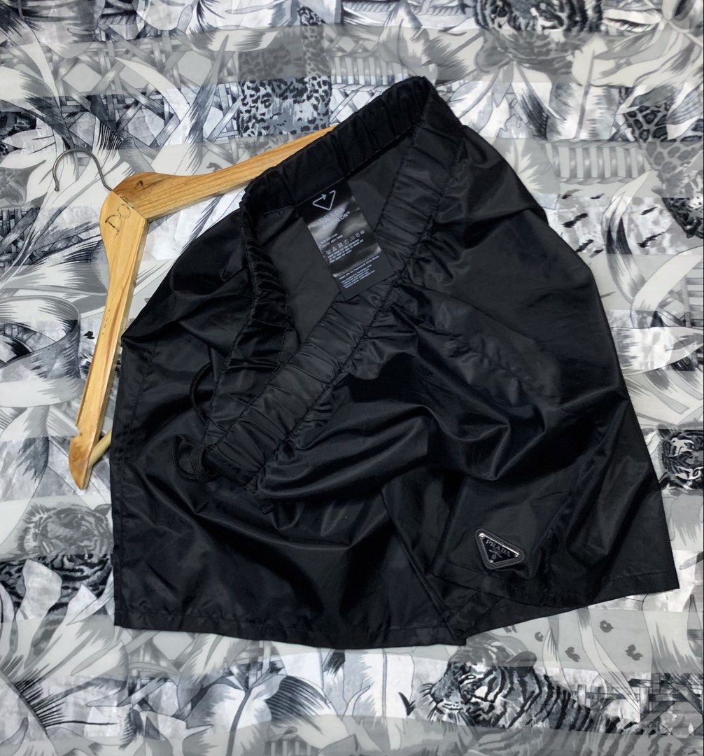 Prada Re-Nylon Black Shorts (Category: Luxury Apparel) located in Polomolok. Submitted by domingthriftclothes (Listing ID 1464687938, Image 3). Description: - Brand: Prada - Item: Re-Nylon Black Shorts - Condition: Pristine / Like New - Details: Iconic enamel triangle logo on lower leg - Fit: Elastic waistband with adjustable drawstring - Material: Sustainable recycled nylon - Style: Luxury streetwear, highly versatile for daily wear - Authentici