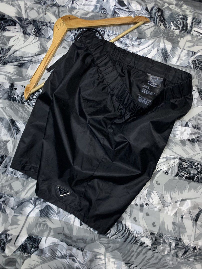 Prada Re-Nylon Black Shorts (Category: Luxury Apparel) located in Polomolok. Submitted by domingthriftclothes (Listing ID 1464687938, Image 1). Description: - Brand: Prada - Item: Re-Nylon Black Shorts - Condition: Pristine / Like New - Details: Iconic enamel triangle logo on lower leg - Fit: Elastic waistband with adjustable drawstring - Material: Sustainable recycled nylon - Style: Luxury streetwear, highly versatile for daily wear - Authentici