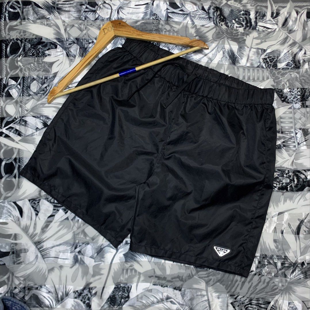 Prada Re-Nylon Black Shorts (Category: Luxury Apparel) located in Polomolok. Submitted by domingthriftclothes (Listing ID 1464687938, Image 2). Description: - Brand: Prada - Item: Re-Nylon Black Shorts - Condition: Pristine / Like New - Details: Iconic enamel triangle logo on lower leg - Fit: Elastic waistband with adjustable drawstring - Material: Sustainable recycled nylon - Style: Luxury streetwear, highly versatile for daily wear - Authentici