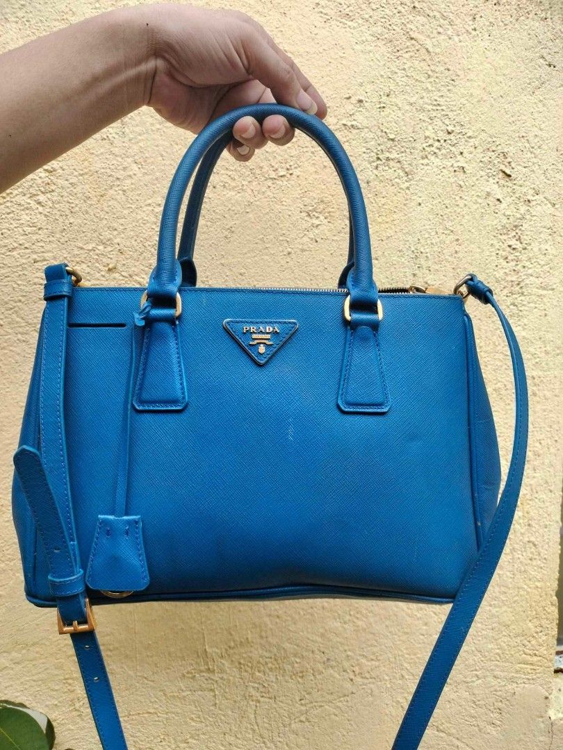 Prada Saffiano Lux Tote Bag Blue (Category: Luxury Bags & Wallets) located in Caloocan City. Submitted by tinshaoshop (Listing ID 1464634107, Image 1). Description: - Authentic Prada bag - Vibrant blue Saffiano leather - Gold hardware details - Top handles and detachable shoulder strap - Multiple interior compartments - Perfect for daily use or special occasions - with minor flaws - loc. Cabuyao Laguna.