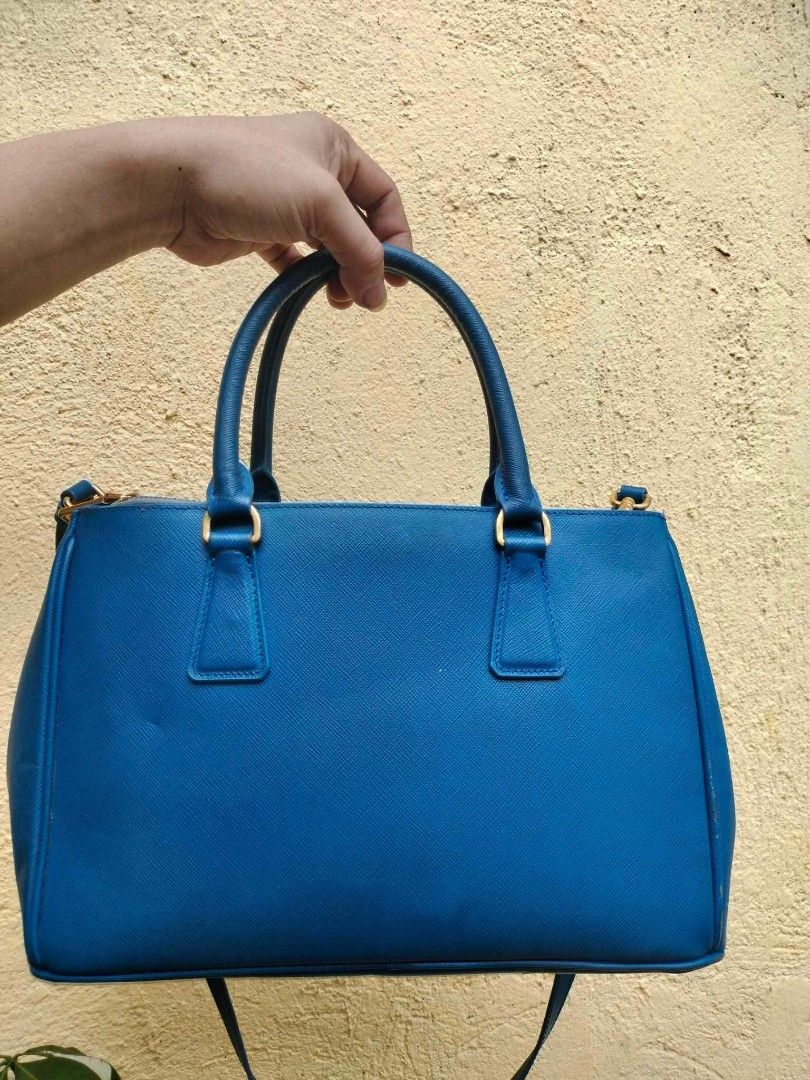 Prada Saffiano Lux Tote Bag Blue (Category: Luxury Bags & Wallets) located in Caloocan City. Submitted by tinshaoshop (Listing ID 1464634107, Image 2). Description: - Authentic Prada bag - Vibrant blue Saffiano leather - Gold hardware details - Top handles and detachable shoulder strap - Multiple interior compartments - Perfect for daily use or special occasions - with minor flaws - loc. Cabuyao Laguna.