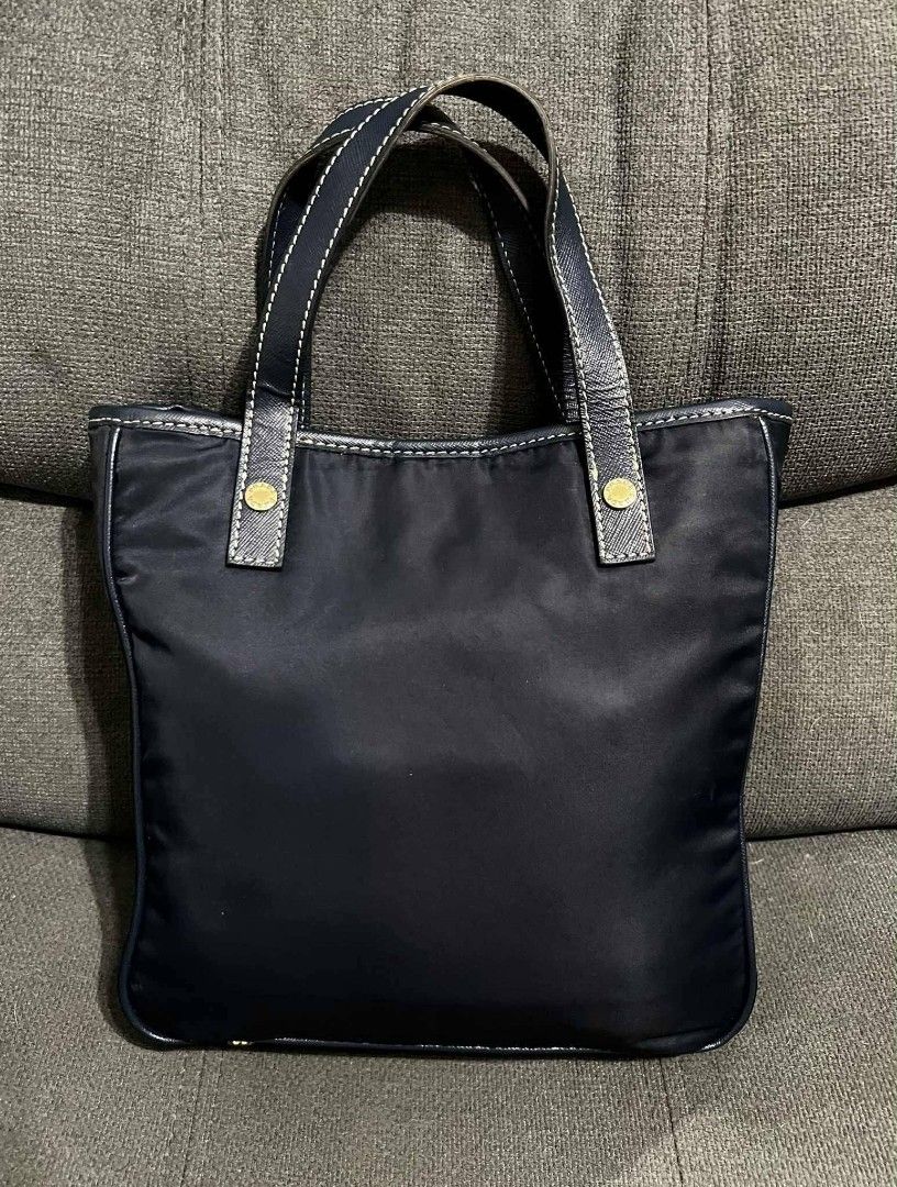 Prada small tote (Category: Shoulder Bags) located in Quezon City. Submitted by luxxechic (Listing ID 1464571797, Image 2). Description: riri under zip with etiketa navy blue color nylon and leather material size: L-11in/H-11in no issue like new actual photo posted japan preloved mop: gcash.
