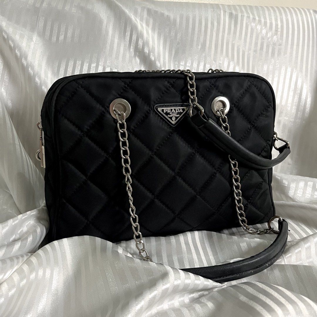 FREE SF| PRADA VINTAGE QUILTED NYLON CHAIN SHOULDER BAG (Category: Shoulder Bags) located in Manila. Submitted by ave.archives (Listing ID 1464655007, Image 3). Description: PRADA Vintage Quilted Nylon Bag — classic black quilted nylon design featuring the iconic Prada Milano triangular logo, silver-tone chain handles, and shoulder strap. Authenticity shown in photos available. Good pre-loved condition; please see photos for actual condition and 