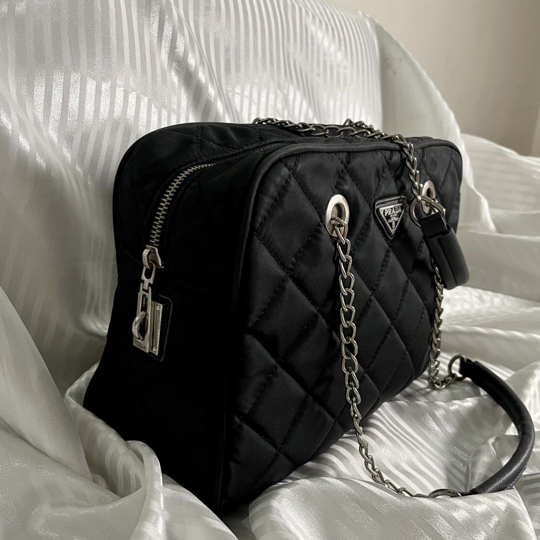 FREE SF| PRADA VINTAGE QUILTED NYLON CHAIN SHOULDER BAG (Category: Shoulder Bags) located in Manila. Submitted by ave.archives (Listing ID 1464655007, Image 2). Description: PRADA Vintage Quilted Nylon Bag — classic black quilted nylon design featuring the iconic Prada Milano triangular logo, silver-tone chain handles, and shoulder strap. Authenticity shown in photos available. Good pre-loved condition; please see photos for actual condition and 