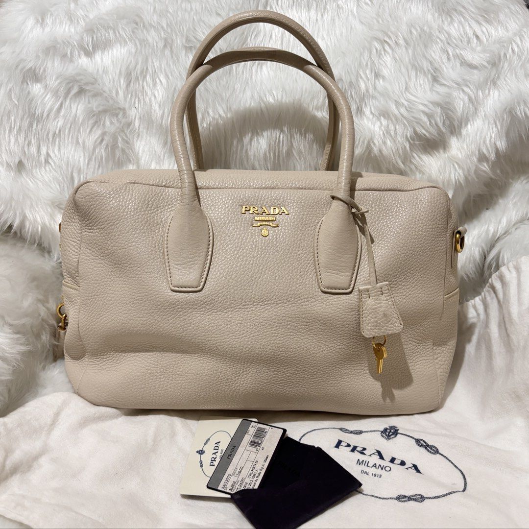 Prada Vitello Phenix Bauletto Bag (Category: Luxury Bags & Wallets) located in Quezon City. Submitted by leens.preloved (Listing ID 1462628837, Image 1). Description: - Authentic Prada tote bag - Material: Off-white Vitello Daino leather - Hardware: Gold - Features: Spacious interior, ideal for daily use Message me for more photos .