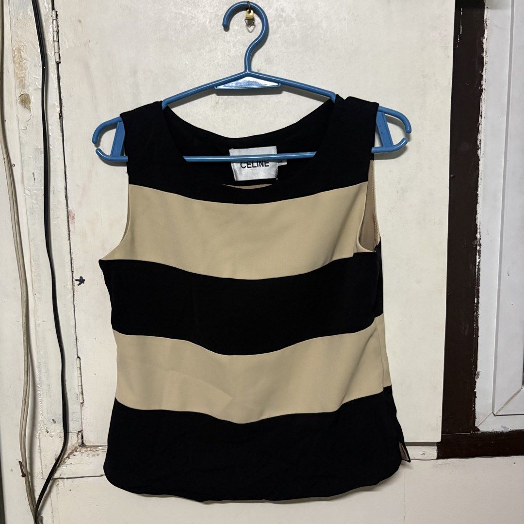 Preloved CELINE Striped Sleeveless Top Blouse (Category: Sleeveless) located in Manila. Submitted by zzajmr (Listing ID 1464666830, Image 1). Description: - Celine sleeveless top - Classic black and beige horizontal stripes - Convenient side zipper closure - Tagged size L - Versatile for casual outfits or layering can fit medium to large.
