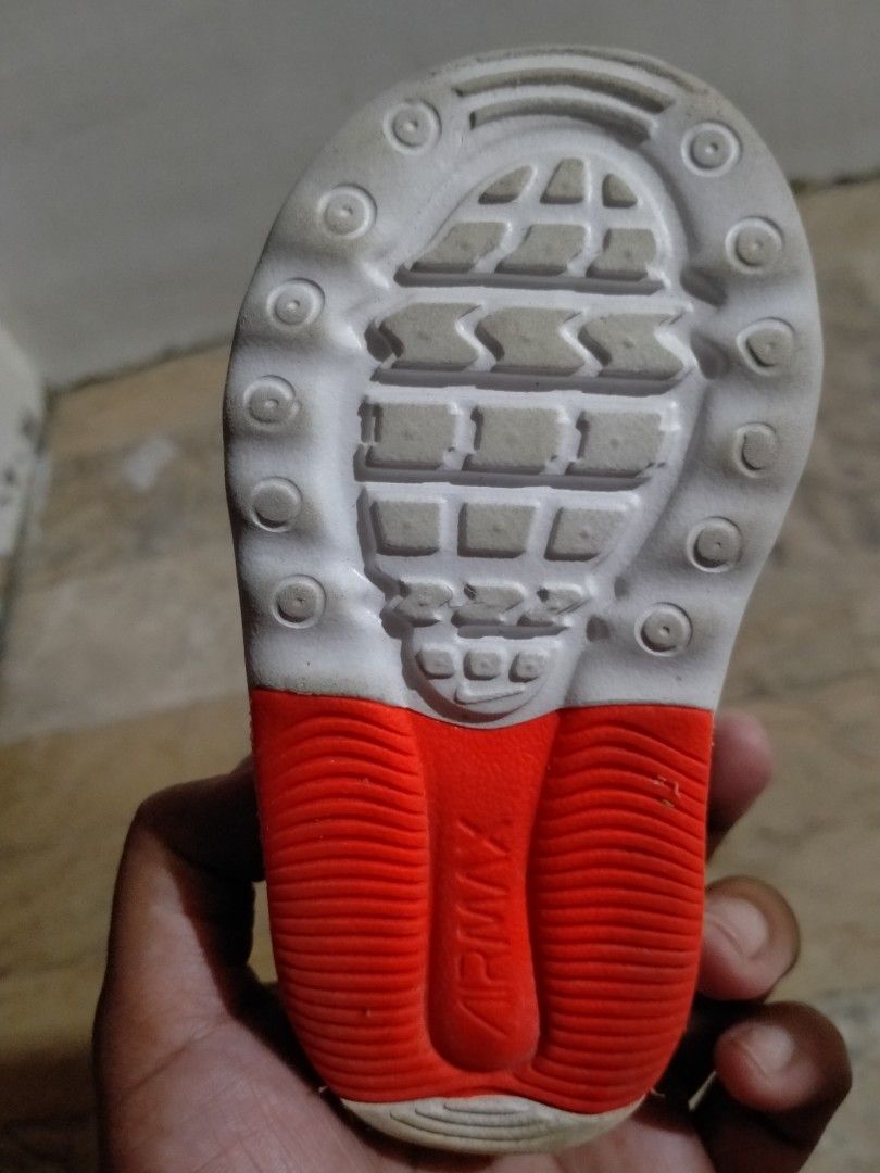 PRELOVED Nike Air Max Bolt dark grey/5C/ (Category: Babies & Kids Fashion) located in Cainta. Submitted by mommysam28 (Listing ID 1464764826, Image 3). Description: This is a toddler's Nike Air Max Bolt sneaker, highlighted by its vibrant red pull tab on the velcro strap.