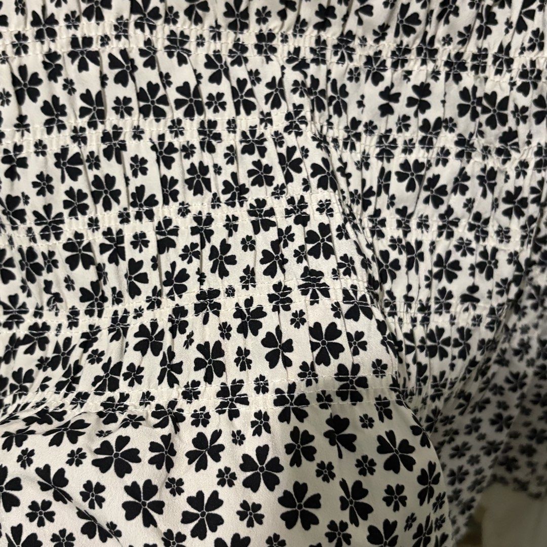 Preloved White Collared Blouse with Black Floral Smocked Front (Category: Blouses) located in Manila. Submitted by zzajmr (Listing ID 1464661584, Image 3). Description: - White long-sleeved blouse - Collared neckline - Smocked front panel with black floral print - Slightly gathered cuffs - Versatile: looks great tucked in or worn out - Ideal for dressing up or down size: best fit large to semi XL.