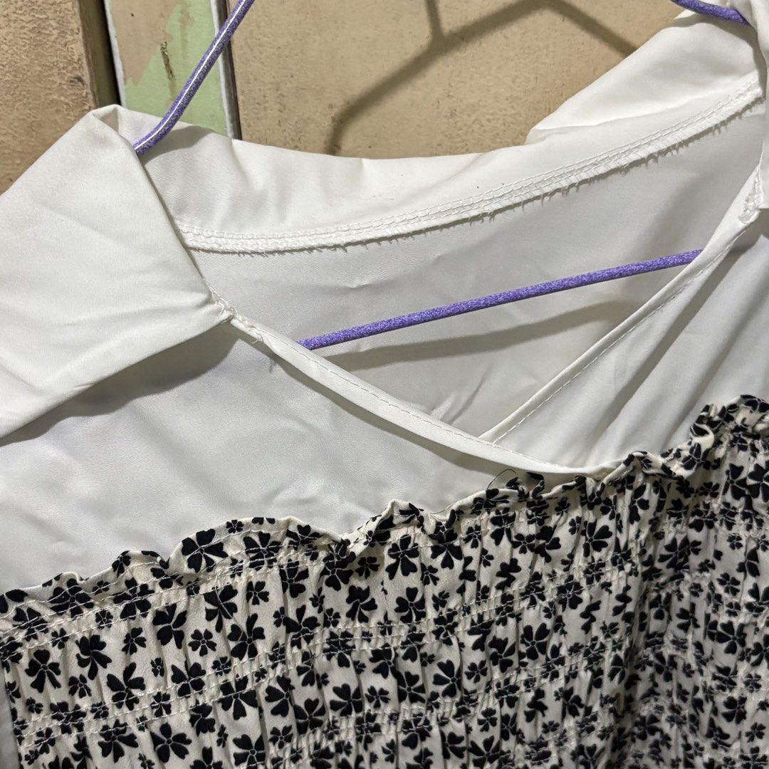 Preloved White Collared Blouse with Black Floral Smocked Front (Category: Blouses) located in Manila. Submitted by zzajmr (Listing ID 1464661584, Image 2). Description: - White long-sleeved blouse - Collared neckline - Smocked front panel with black floral print - Slightly gathered cuffs - Versatile: looks great tucked in or worn out - Ideal for dressing up or down size: best fit large to semi XL.