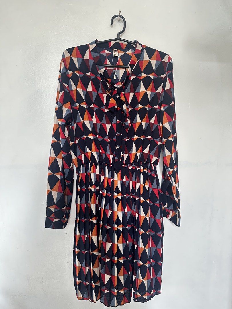 Printed (Geometric) Long-Sleeve Dress (Category: Dresses) located in Taguig. Submitted by closetbyenya (Listing ID 1464630968, Image 1). Description: ✨ Stylish geometric printed dress • Long sleeves with buttoned cuffs • V-neck with cute tie/bow detail • Elasticated waist for a flattering fit • Flowy skirt for a comfortable, feminine look • Colorful geometric print in navy, red, orange & cream • Dress length: 89 cm • Lightweight and easy to wear 