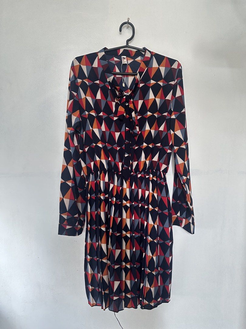Printed (Geometric) Long-Sleeve Dress (Category: Dresses) located in Taguig. Submitted by closetbyenya (Listing ID 1464630968, Image 3). Description: ✨ Stylish geometric printed dress • Long sleeves with buttoned cuffs • V-neck with cute tie/bow detail • Elasticated waist for a flattering fit • Flowy skirt for a comfortable, feminine look • Colorful geometric print in navy, red, orange & cream • Dress length: 89 cm • Lightweight and easy to wear 