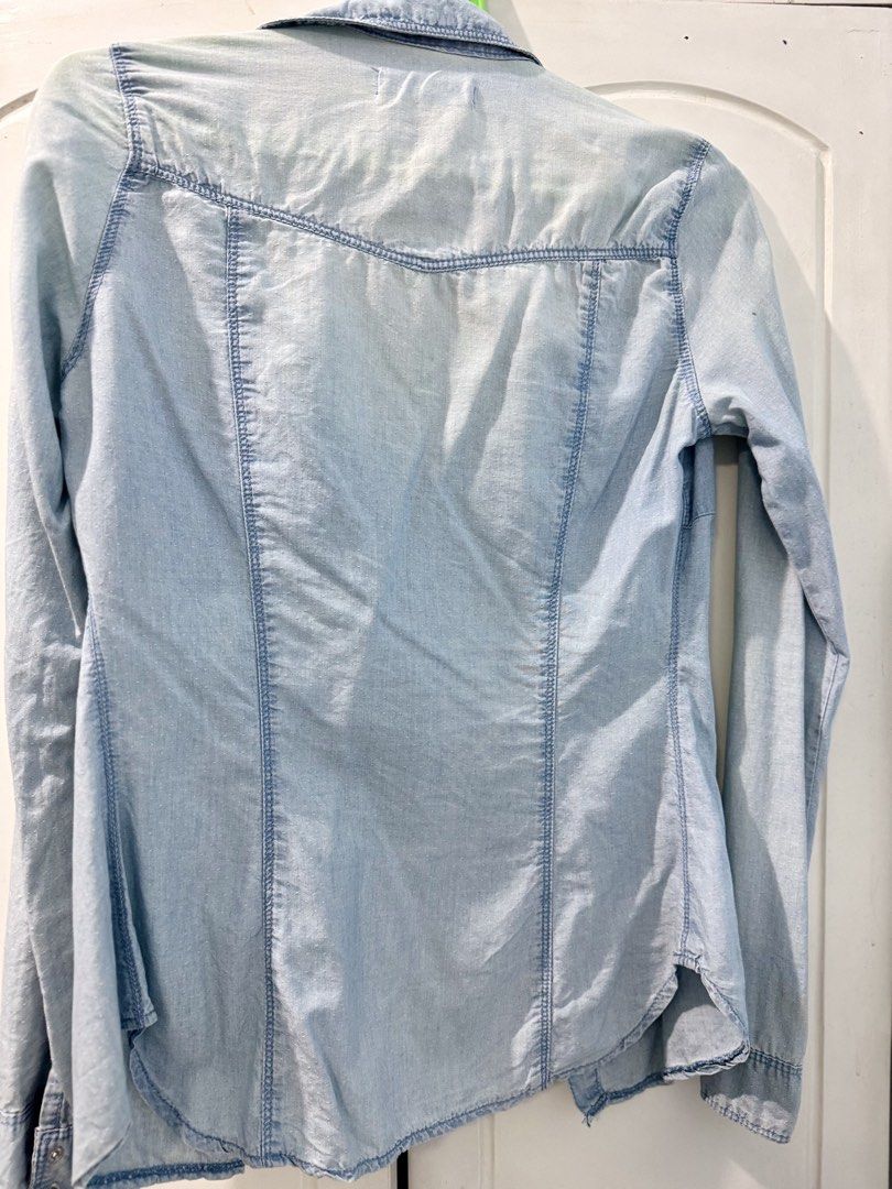 Promod Light Wash Denim Shirt (Category: Shirts) located in Manila. Submitted by melissaal82890 (Listing ID 1464586405, Image 3). Description: - Light wash denim shirt from Promod - Long sleeves with button cuffs - Two chest pockets with button closures - Button-up front - Versatile for layering or wearing on its ownd.